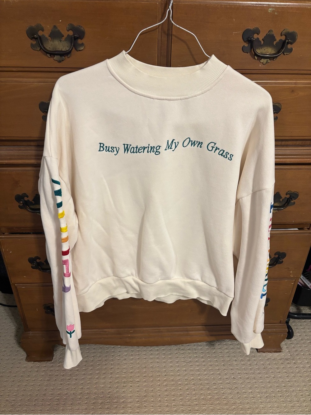 Yellow the label Women's Cream Graphic Sweatshirt - 'Busy Watering My Own Grass'